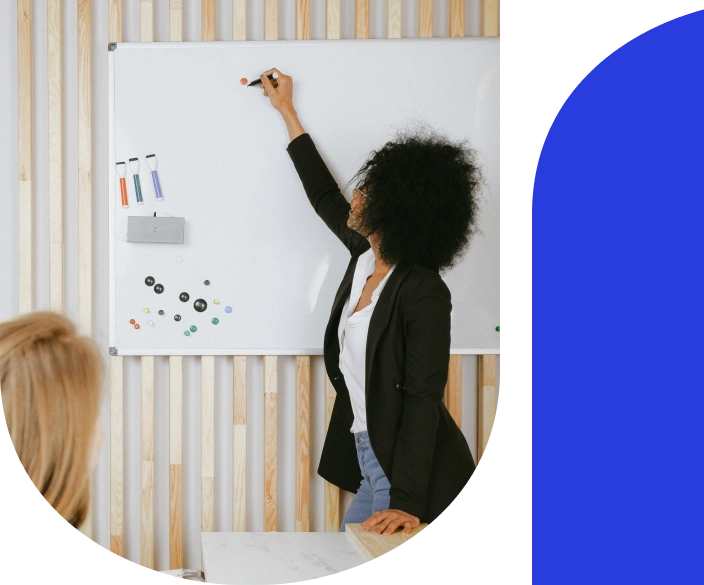 Business woman writing on a white board