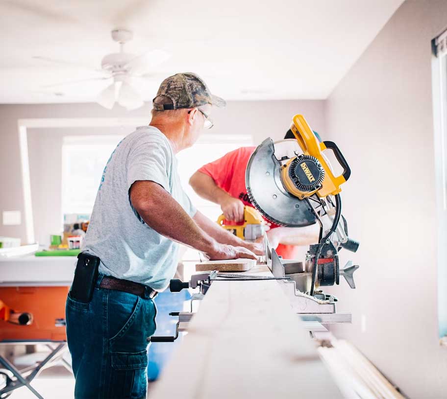 2 men using woodworking equipment